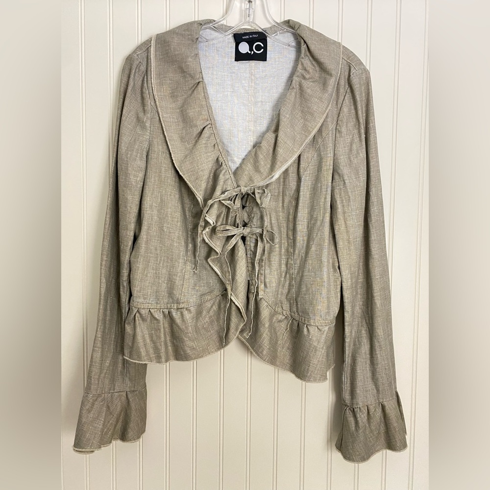 Unique linen jacket with ruffle trim design and ruffle sleeves.